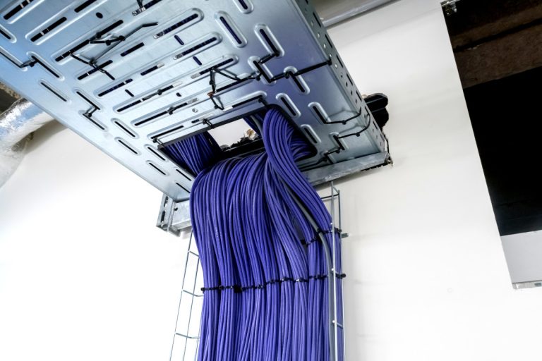 Electrical cables are located in a cableway on the roof of a building